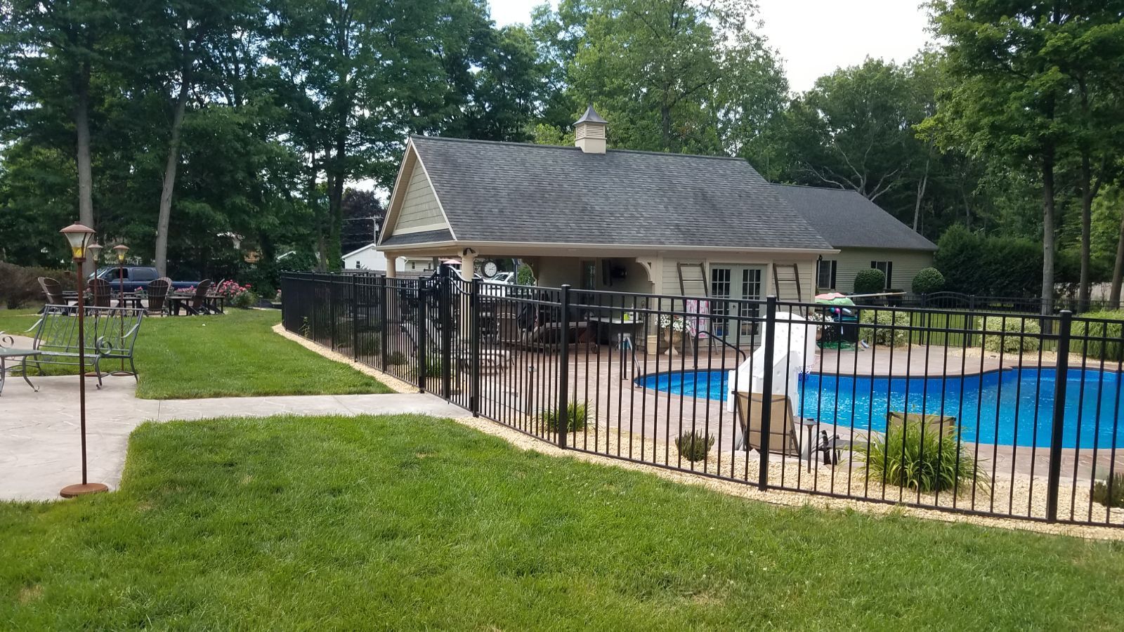 A house with a pool and a fence around it