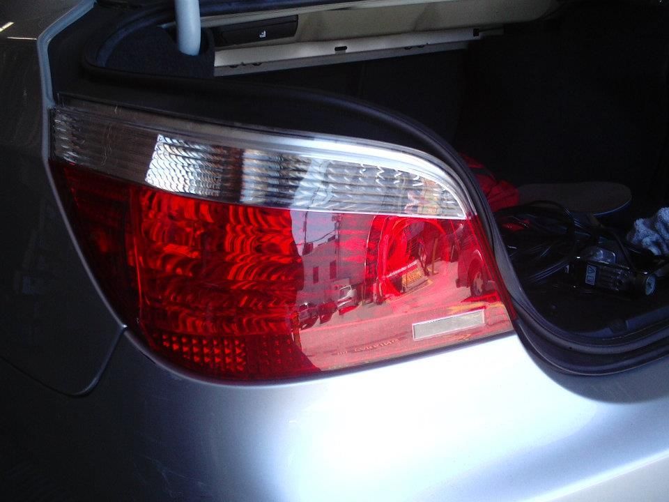A close up of a red tail light on a silver car