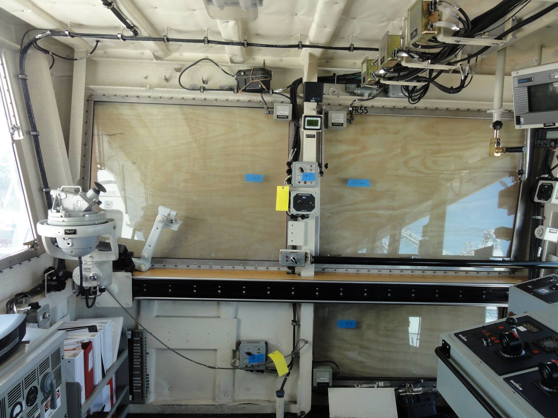 A control room on a ship with a large window