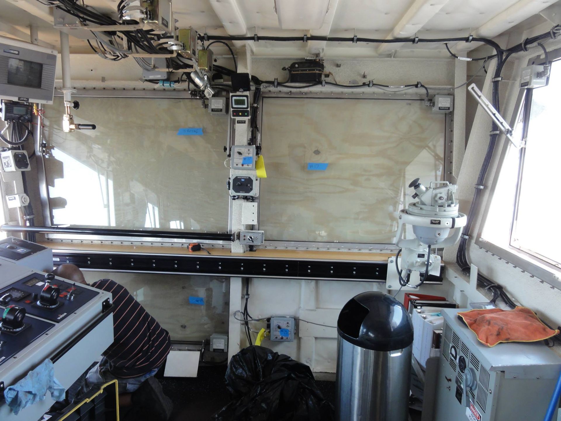 The inside of a boat with a trash can in the middle