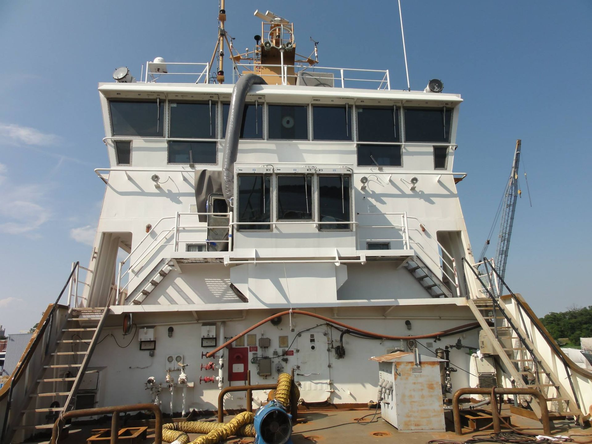 The back of a large white ship with stairs leading up to it