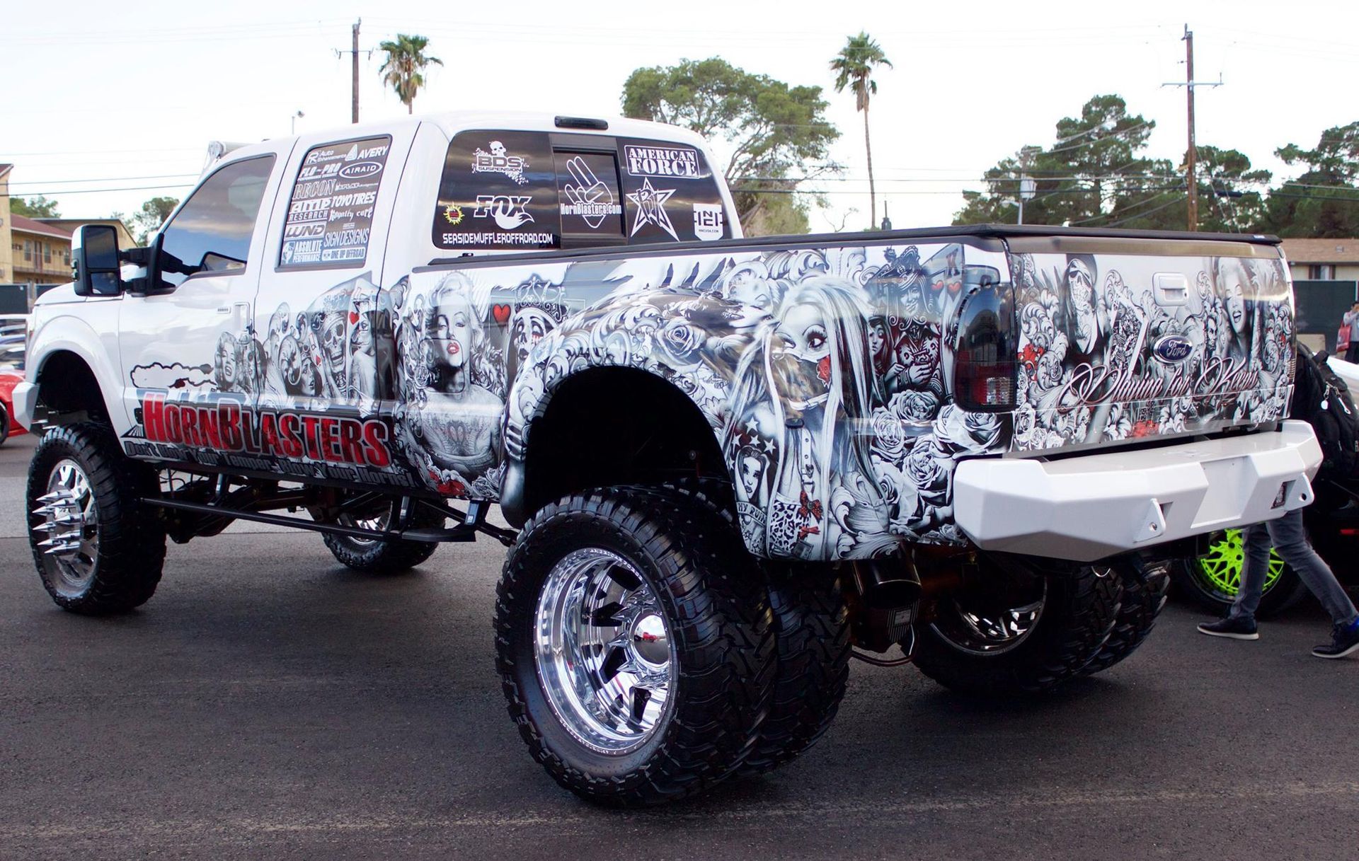 A white truck with a lot of stickers on it