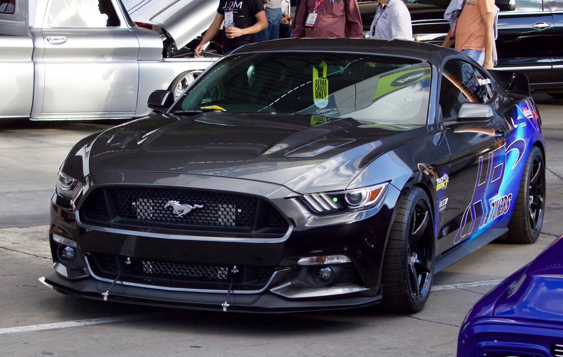 A black ford mustang is parked in a parking lot