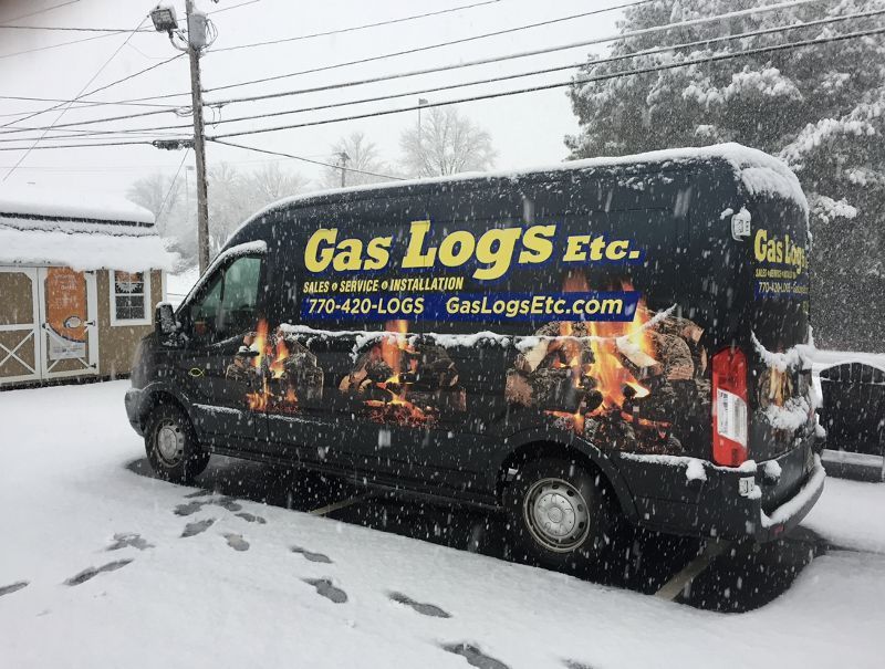 A gas logs van is parked in the snow