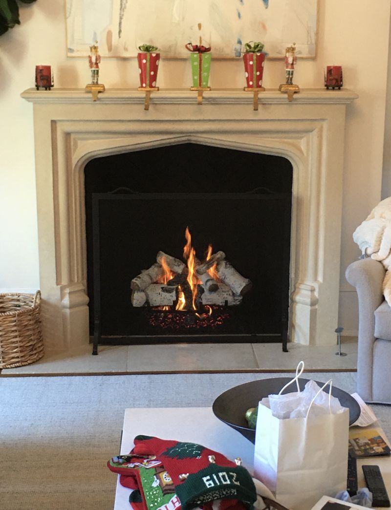 A living room with a fireplace and socks that say ride