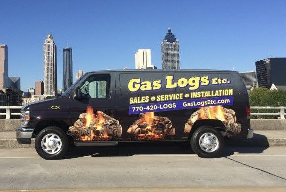 A gas logs van is parked on the side of the road