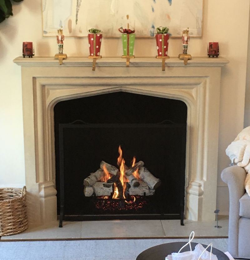 A living room with a fireplace and candles on the mantle
