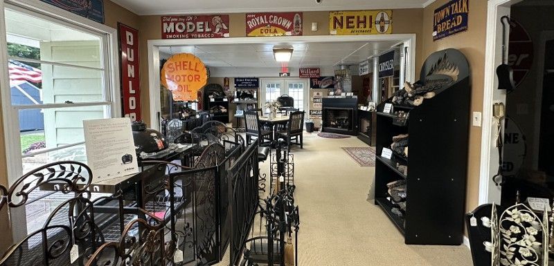 A room with a lot of signs on the wall and a lot of furniture.