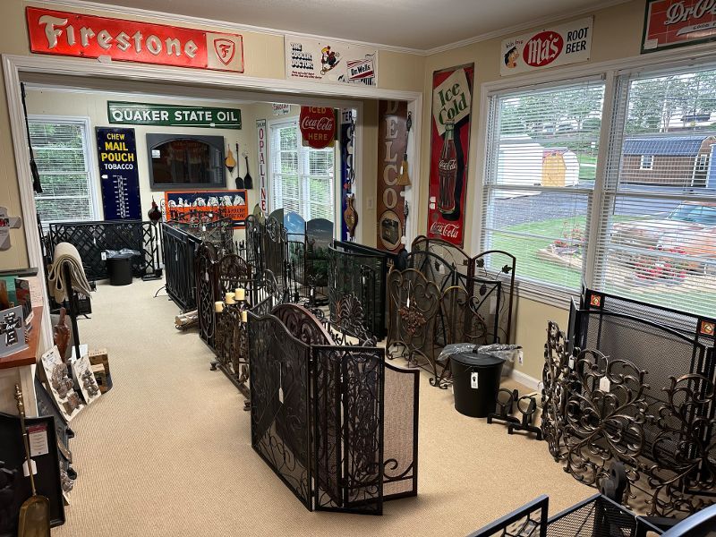 A room with a lot of fireplace screens and signs on the wall.