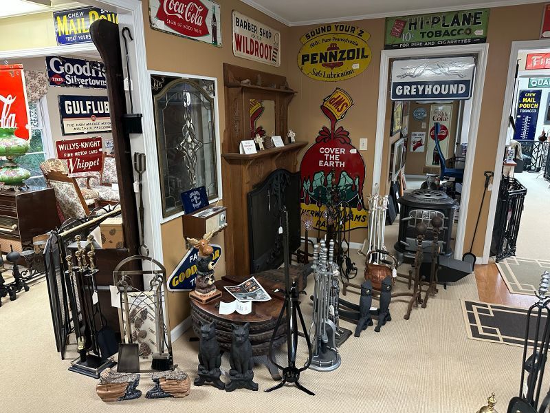 A room filled with lots of signs including one for pennzoil