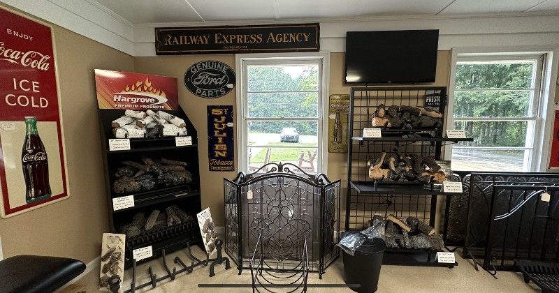 A room with a fireplace and a coca cola sign on the wall