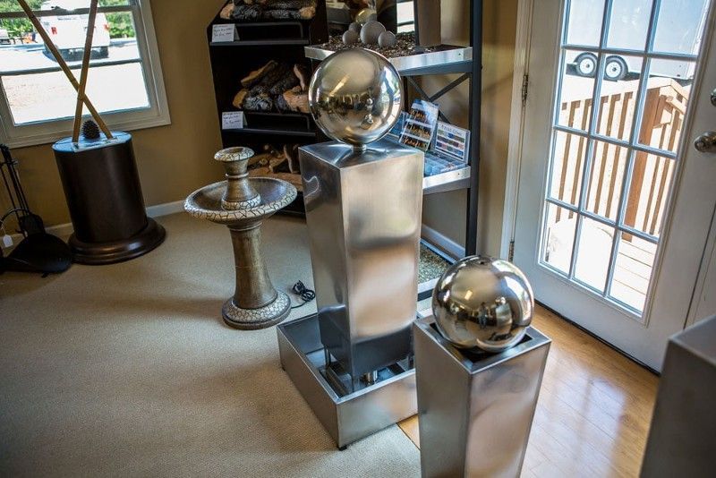 There are three stainless steel fountains in the room.