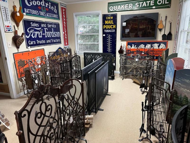 A room with a lot of signs on the wall including one that says quaker state oil