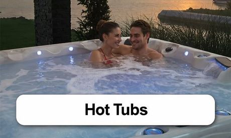 A man and a woman are sitting in a hot tub with the word spas above them