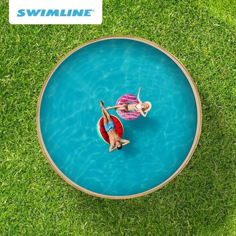 A man and a woman are floating in a swimming pool.