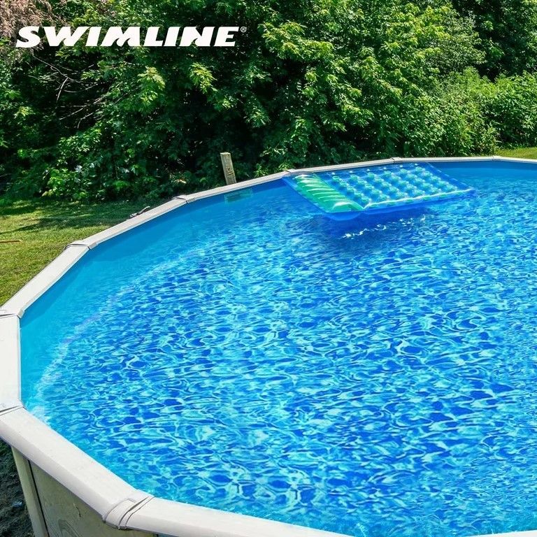 A swimline pool with a raft in it
