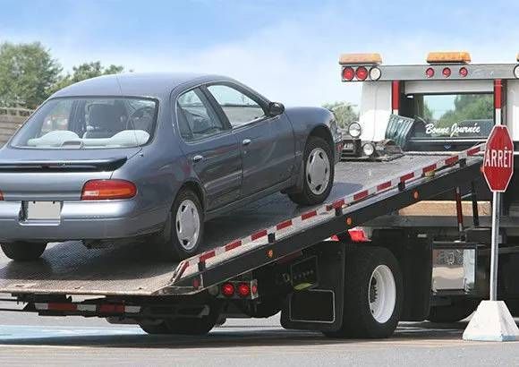 car on flatbed tow truck
