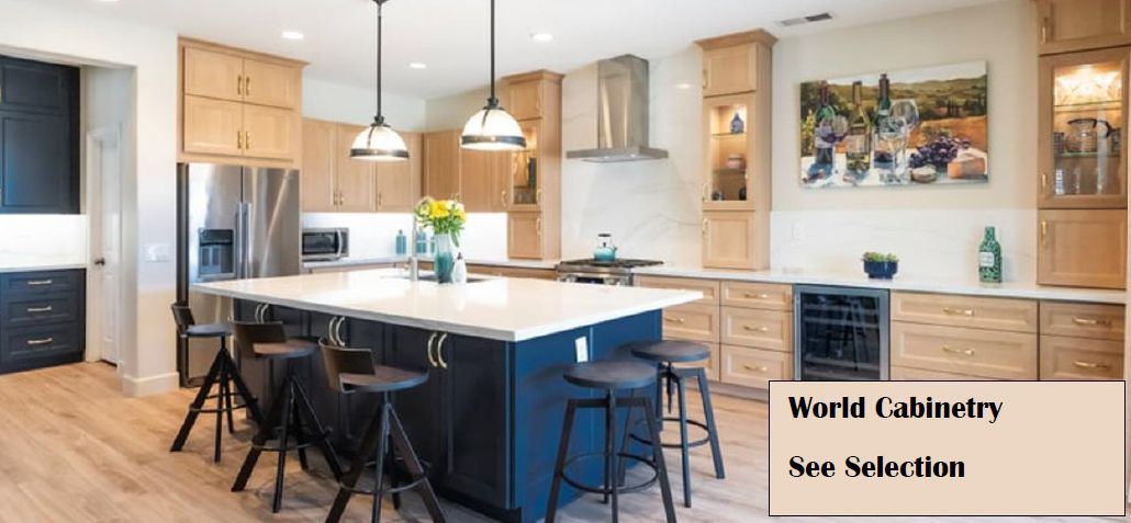 Modern kitchen with navy island, light wood cabinets, stainless steel appliances, and pendant lights.