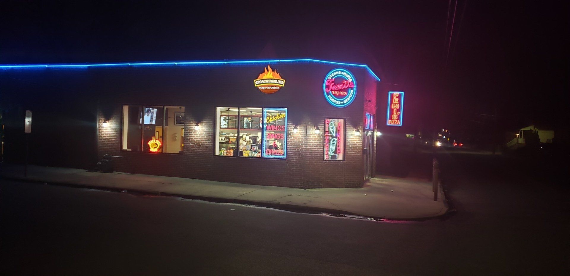 A building with a lot of neon lights on it at night.