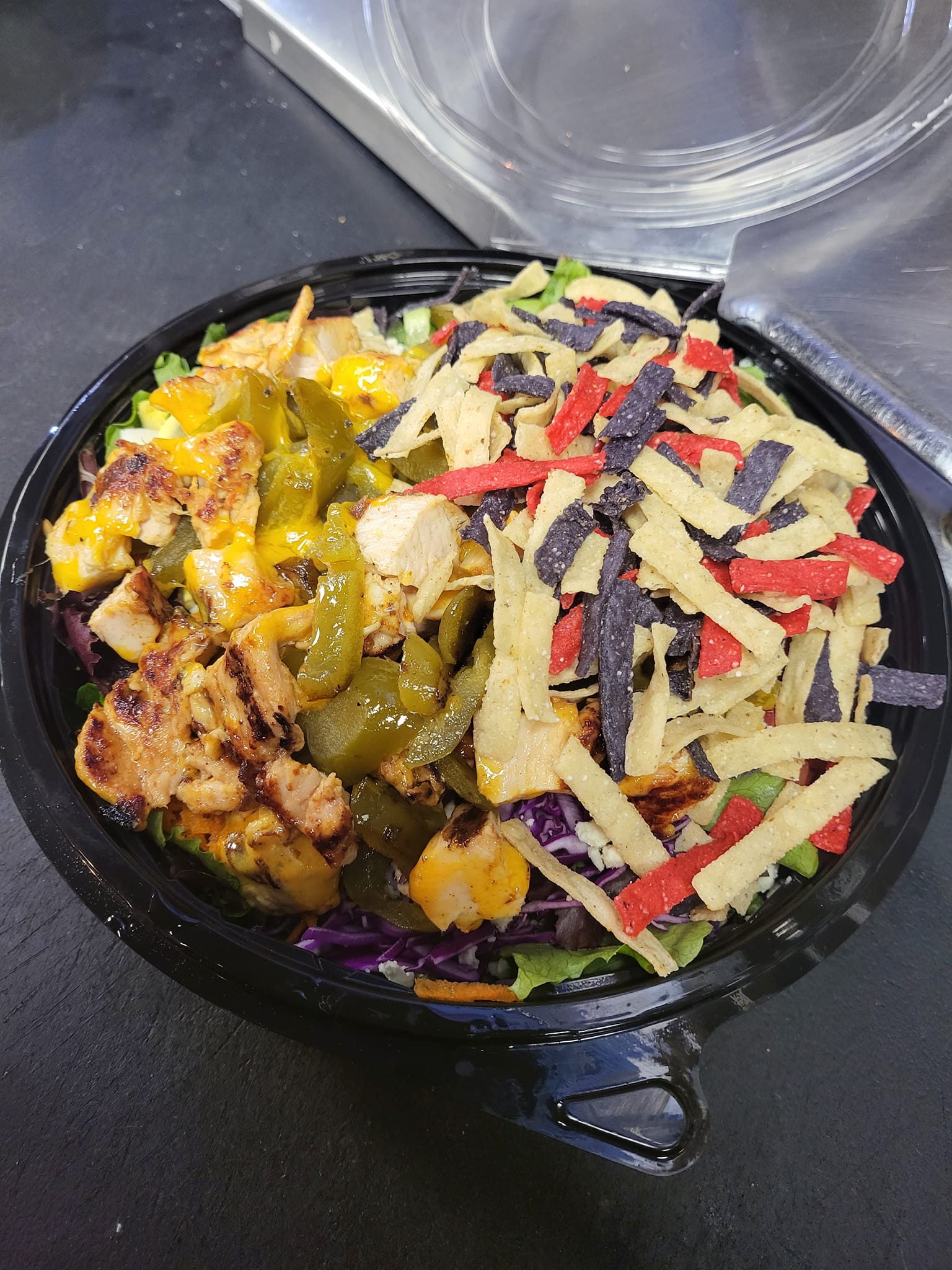 A close up of a salad in a bowl on a table.