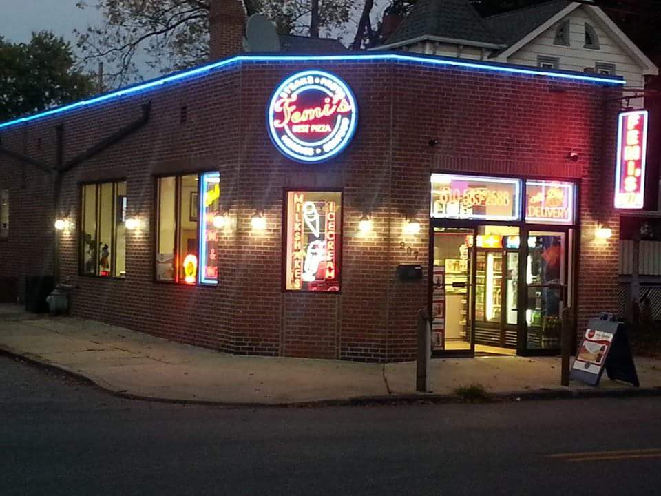 A brick building with a neon sign that says family