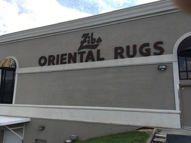 A clean building with a sign that says oriental rugs