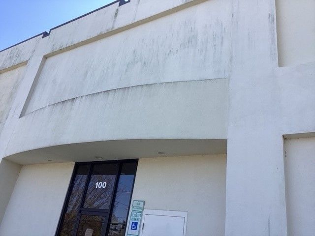 Commercial building wall - before pressure washing service