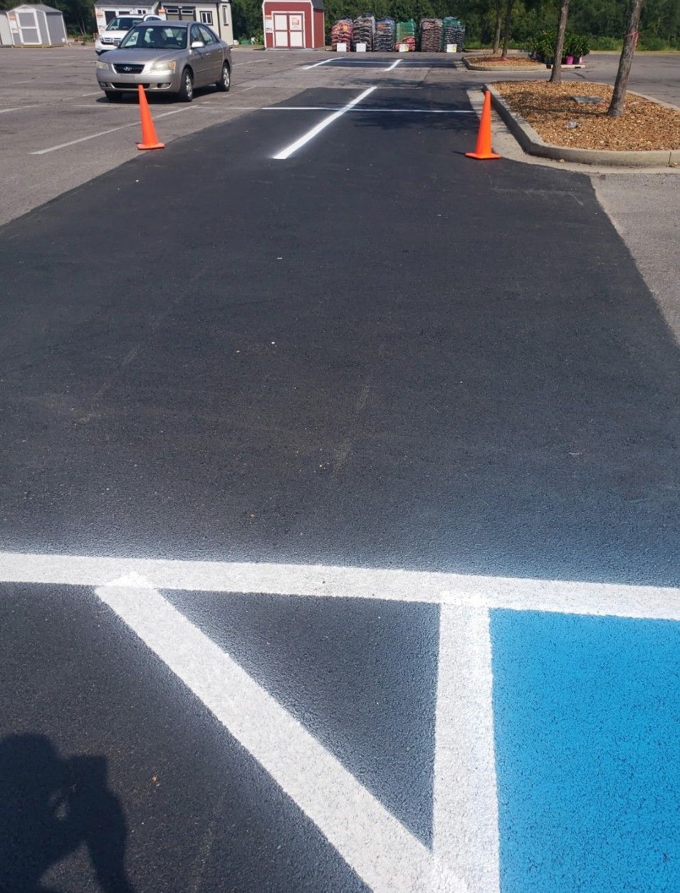Parking lot with newly paved dark asphalt