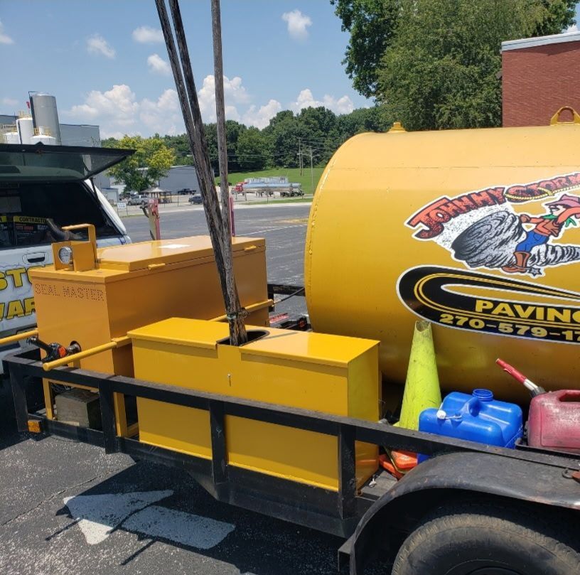Yellow asphalt repair equipment on a trailer