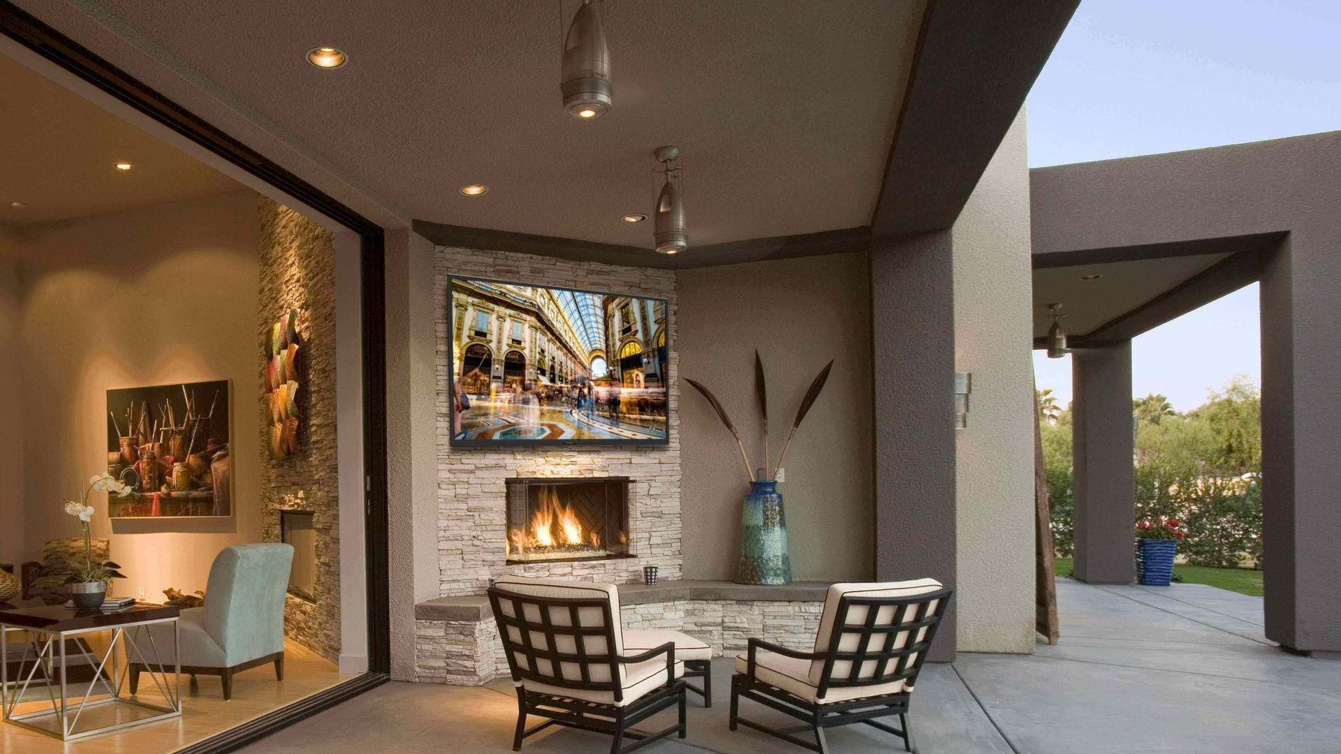 A patio with a fireplace and a flat screen tv