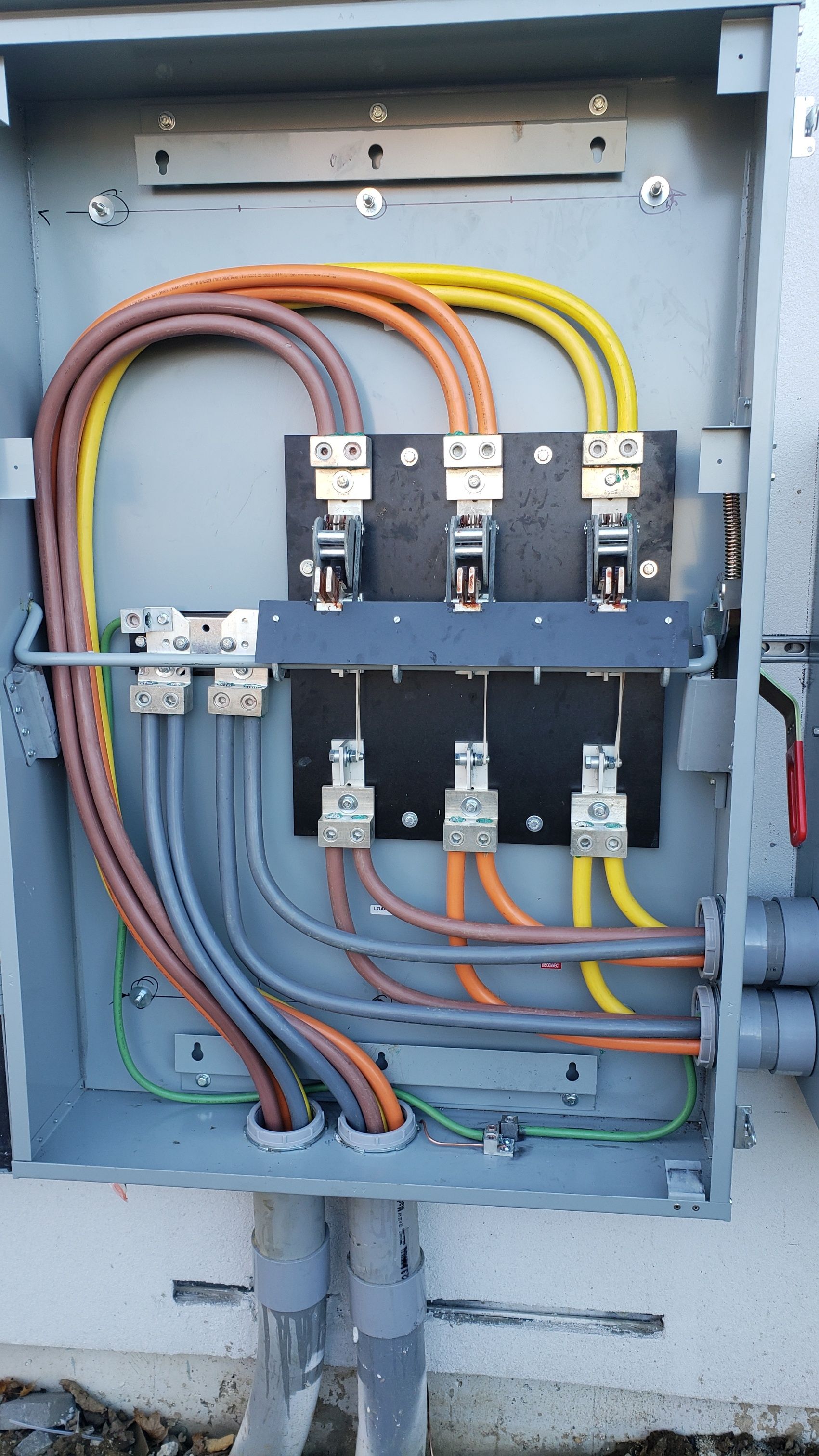 A close-up of an electrical box with a bunch of wires coming out of it.