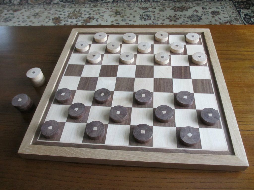 A wooden chess board with wooden pieces on it