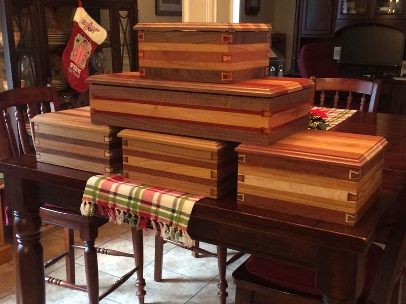 A stack of wooden boxes sitting on top of a wooden table