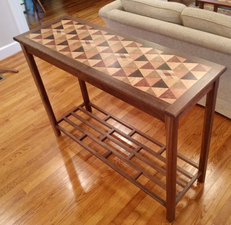 A wooden table with a triangle pattern on it
