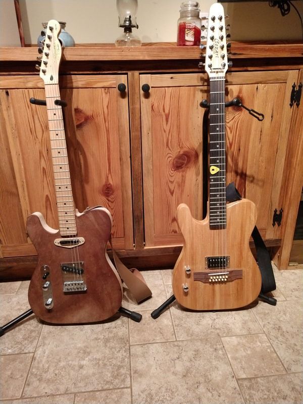Two wooden guitars are sitting next to each other on a tiled floor.