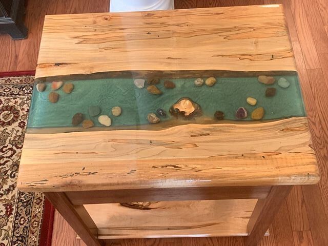 A wooden table with a river in the middle of it