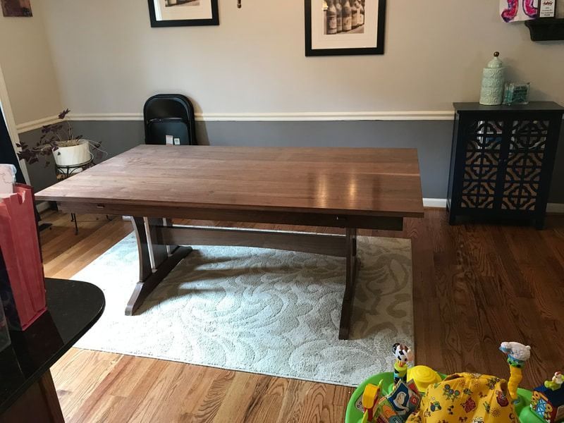 A wooden table is sitting on a rug in a living room.