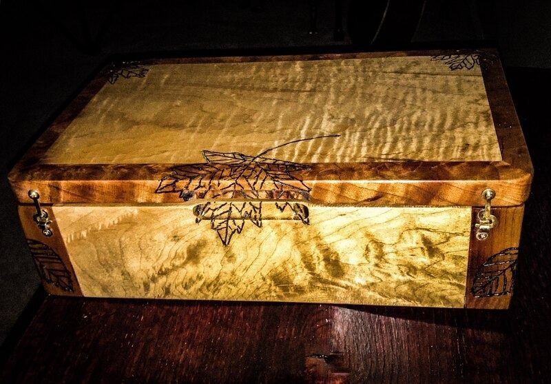A wooden box is sitting on top of a wooden table.