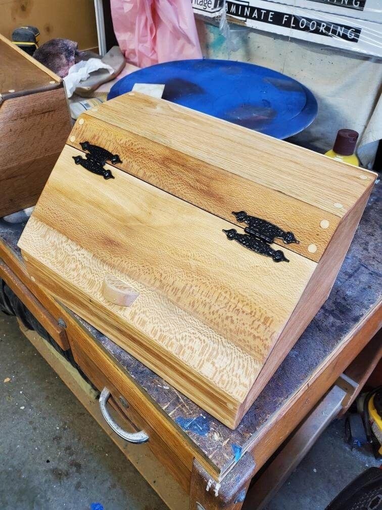 A wooden box is sitting on top of a wooden table.