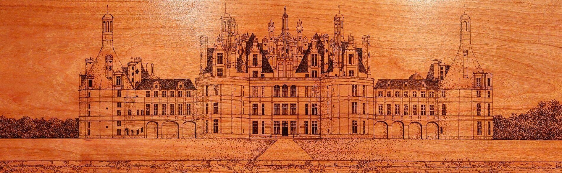 A drawing of a large building on a wooden surface
