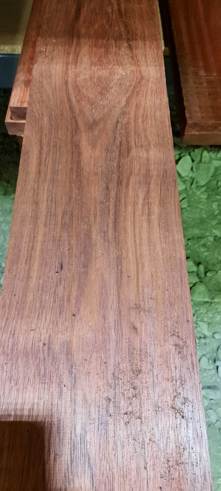 A close up of a piece of wood on a green floor.