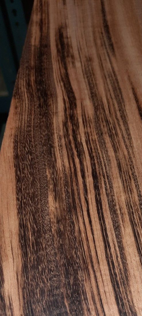 A close up of a piece of wood with a striped pattern.