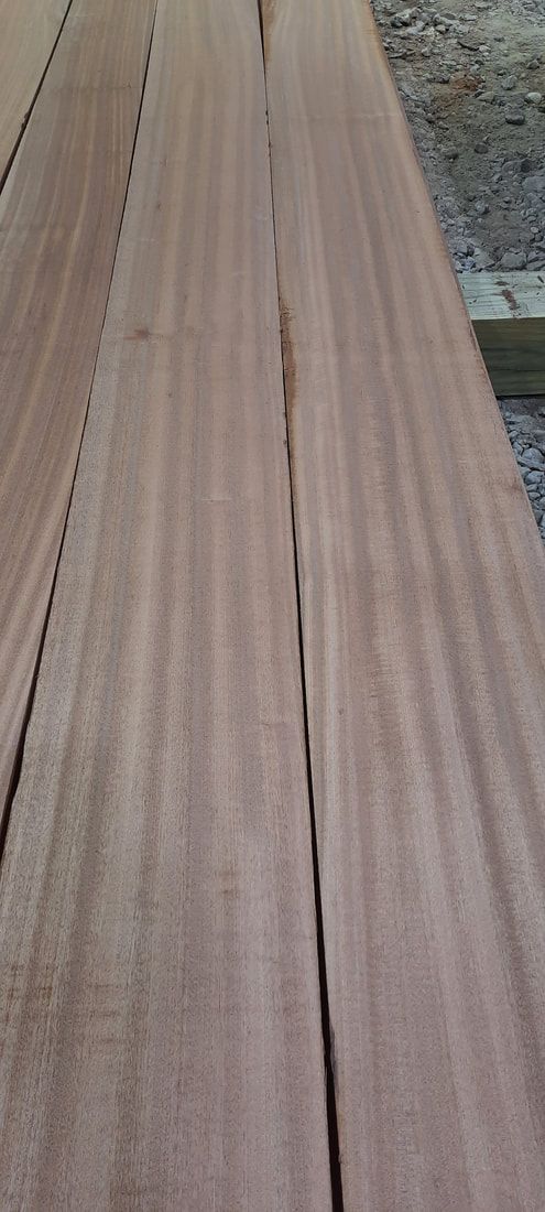 A close up of a piece of wood with a few holes in it.