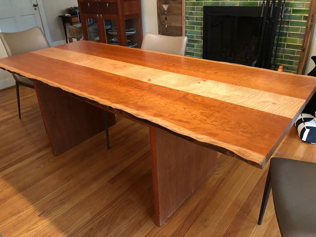A wooden table is sitting on a wooden floor in a living room.