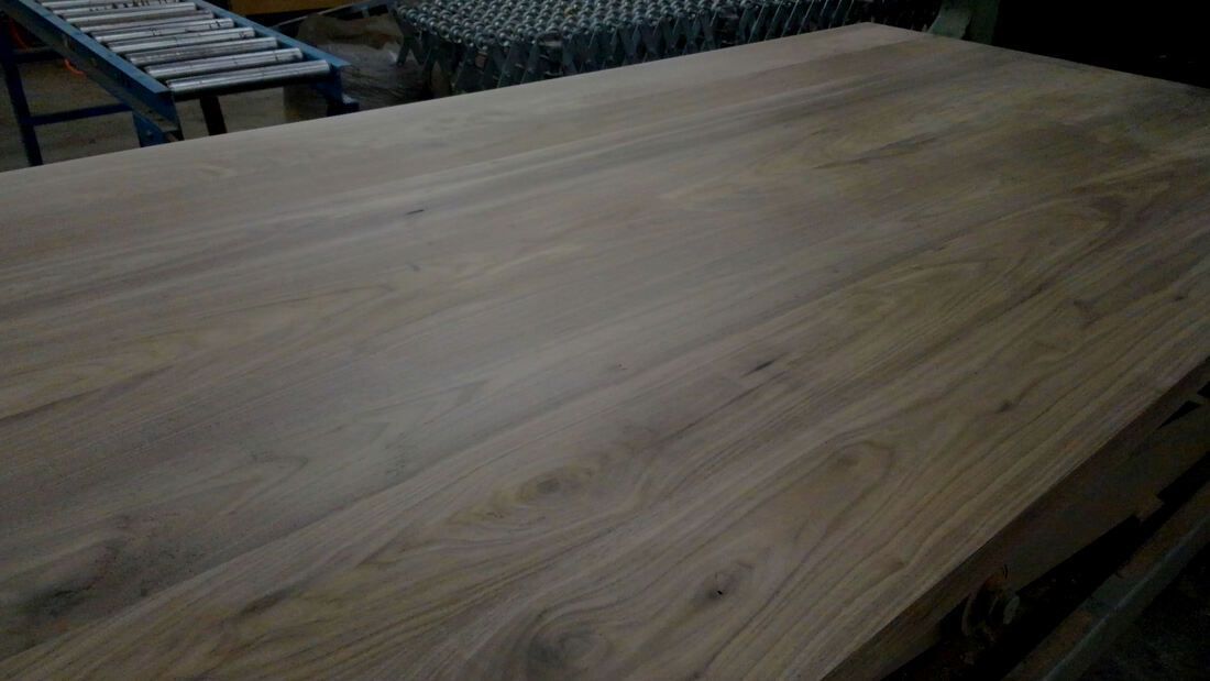 A large piece of wood is sitting on top of a wooden table.