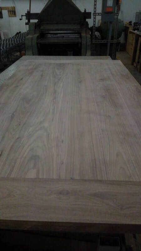 A large piece of wood is sitting on top of a table in a workshop.