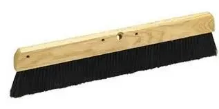 A wide, black-bristled broom head with a wooden handle.