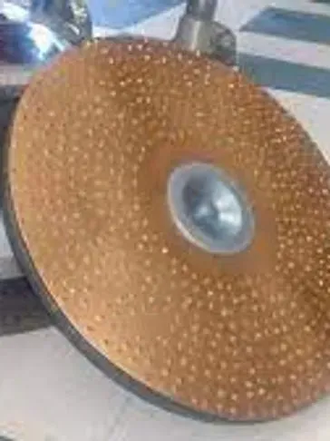 Grinding wheel with abrasive surface and central hole.
