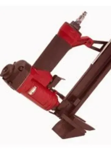 Red and black pneumatic nail gun, angled, with a black magazine.
