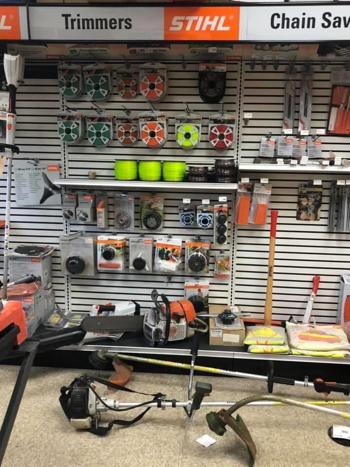 A Stihl store display with trimmers, accessories, and a chainsaw.